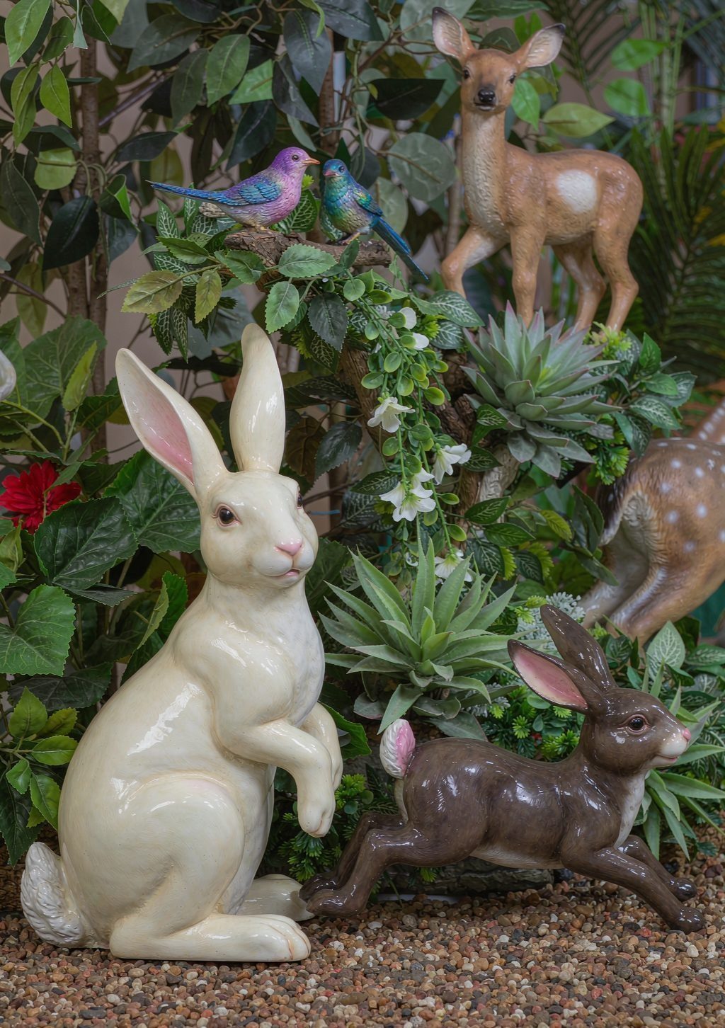 Hand-sculpted artificial topiary animals set into a themed garden planting bed