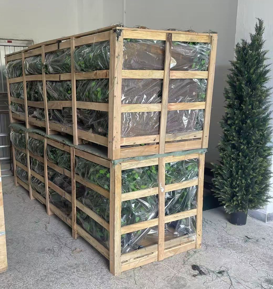 Open timber frame export packing with fork-lift feet holding bagged artificial foliage