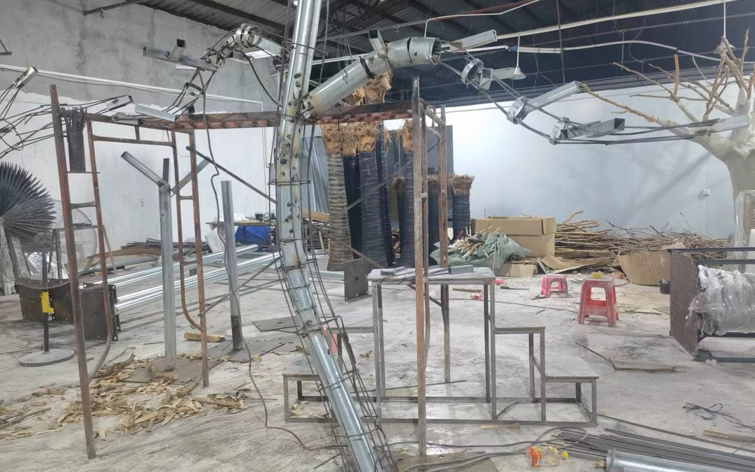 Installation crew anchoring a giant atrium tree to the structural slab