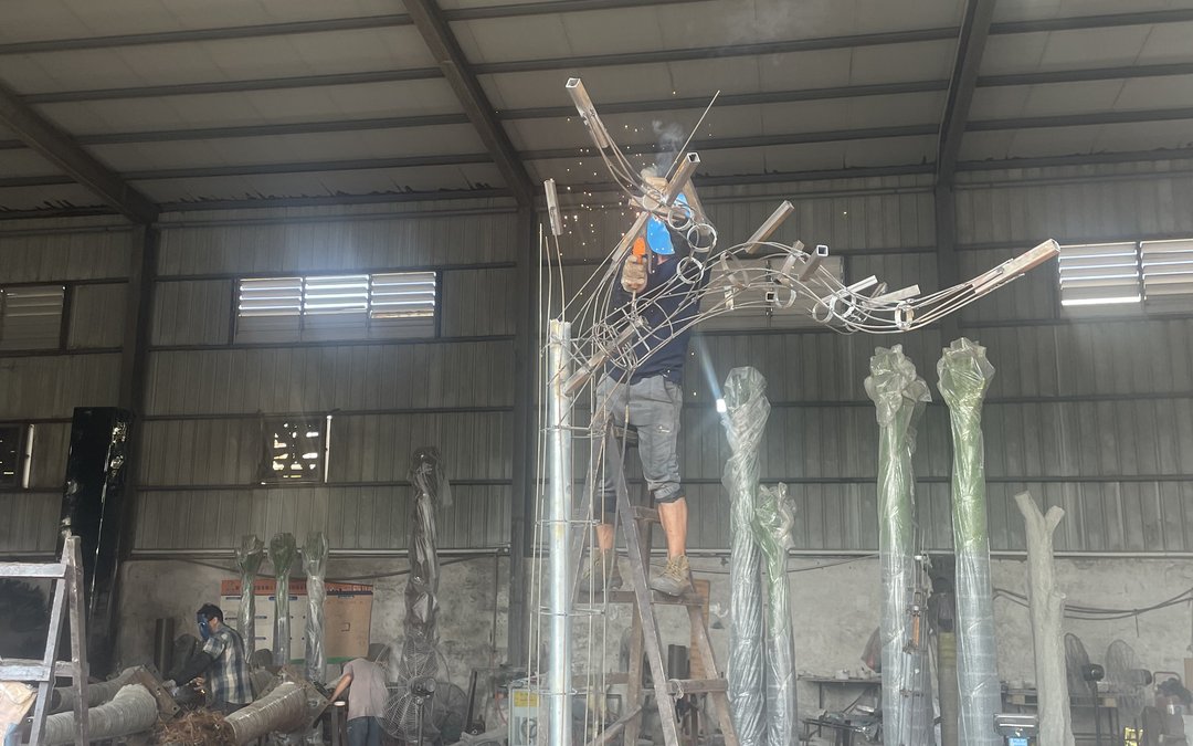 steel frame assembly bay with a tree skeleton being built