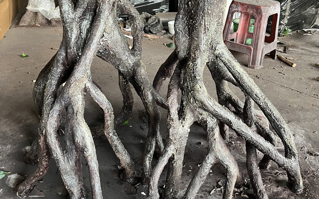 Flared root base of a large artificial tree on the workshop floor