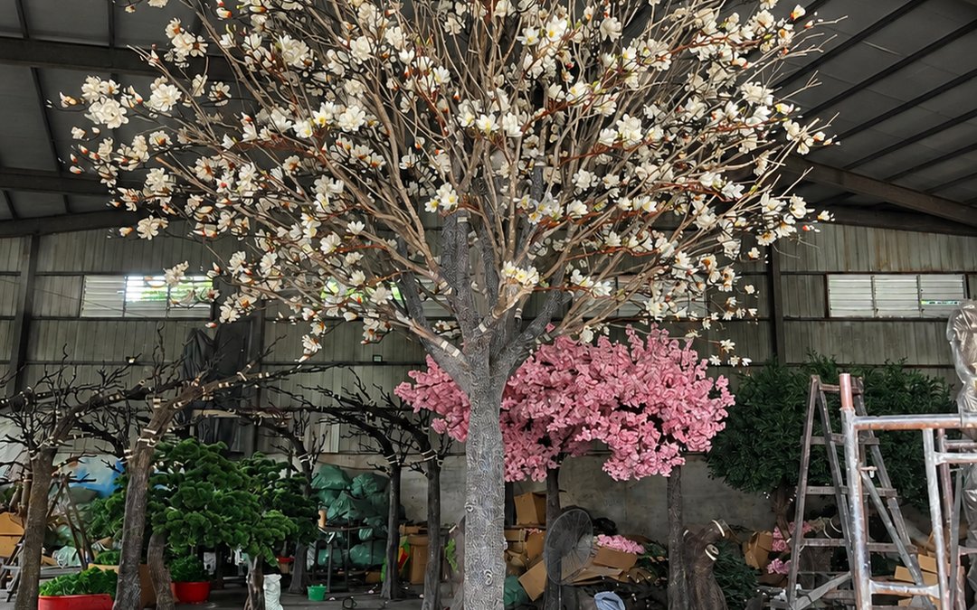 White and pink blossom trees staged in the workshop hall