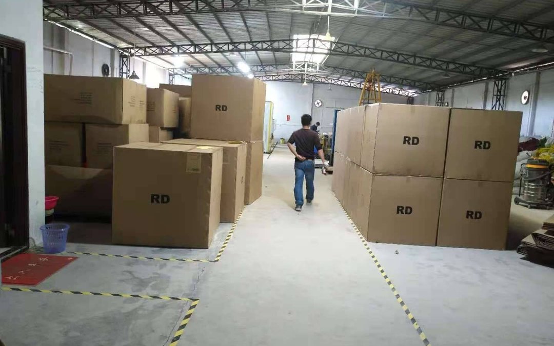 Stacked export cartons marked RD in a warehouse aisle