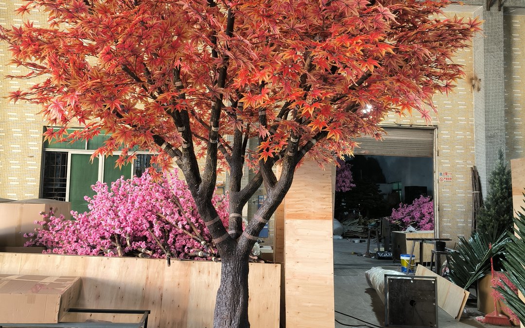 An autumn maple tree standing in the factory yard outside the workshop door