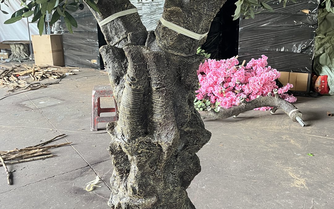 A fibreglass trunk in the workshop with the galvanized core exposed at a branch stub