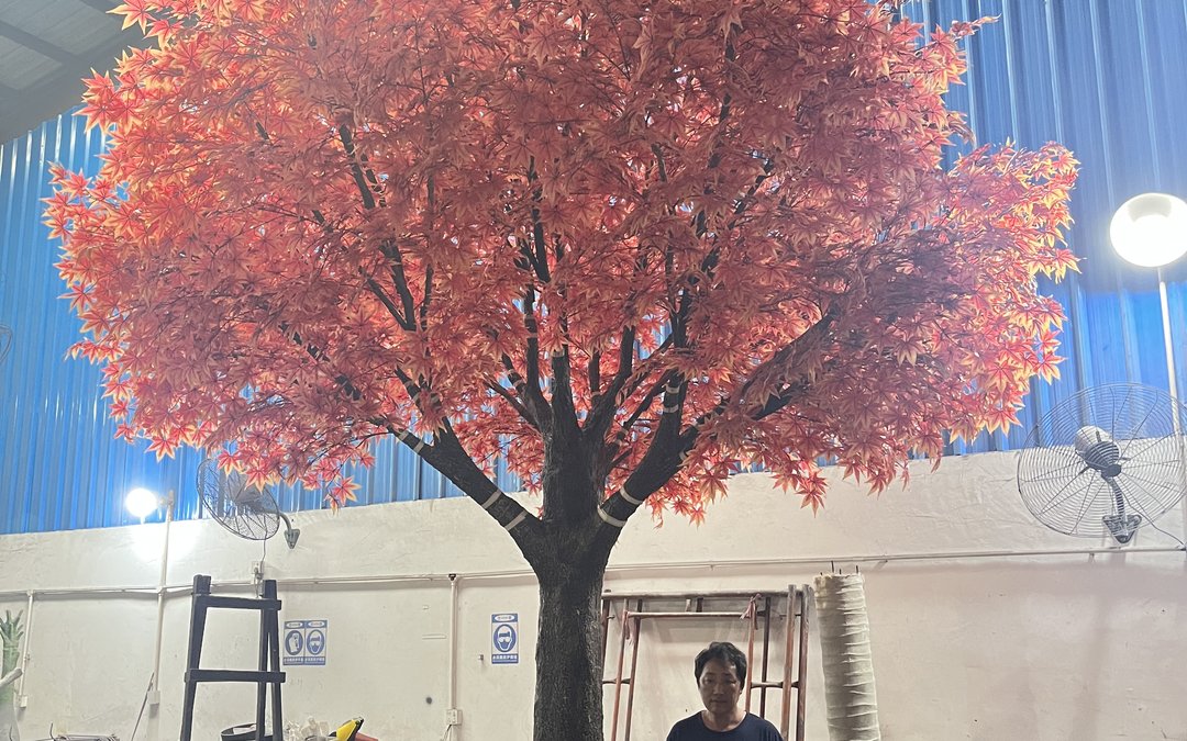 A large artificial maple tree standing in the workshop during trunk and crown assembly