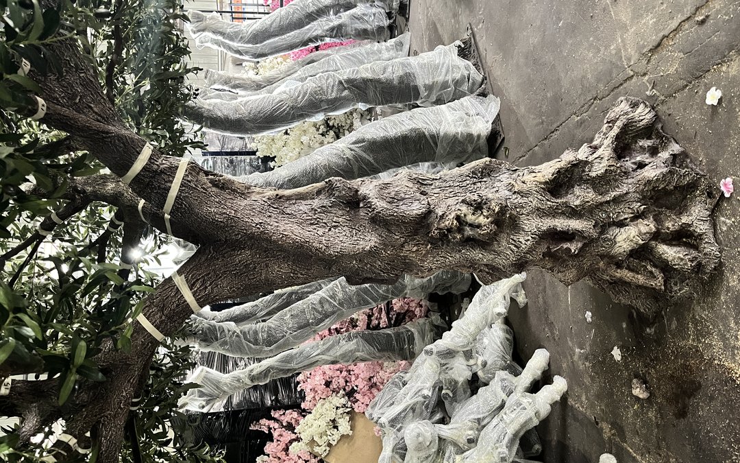 Mixed artificial trees banded and film-wrapped on a pallet before container loading