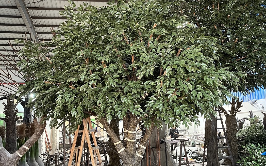 Large artificial tree in a high workshop bay on timber trestles with the trunk banded
