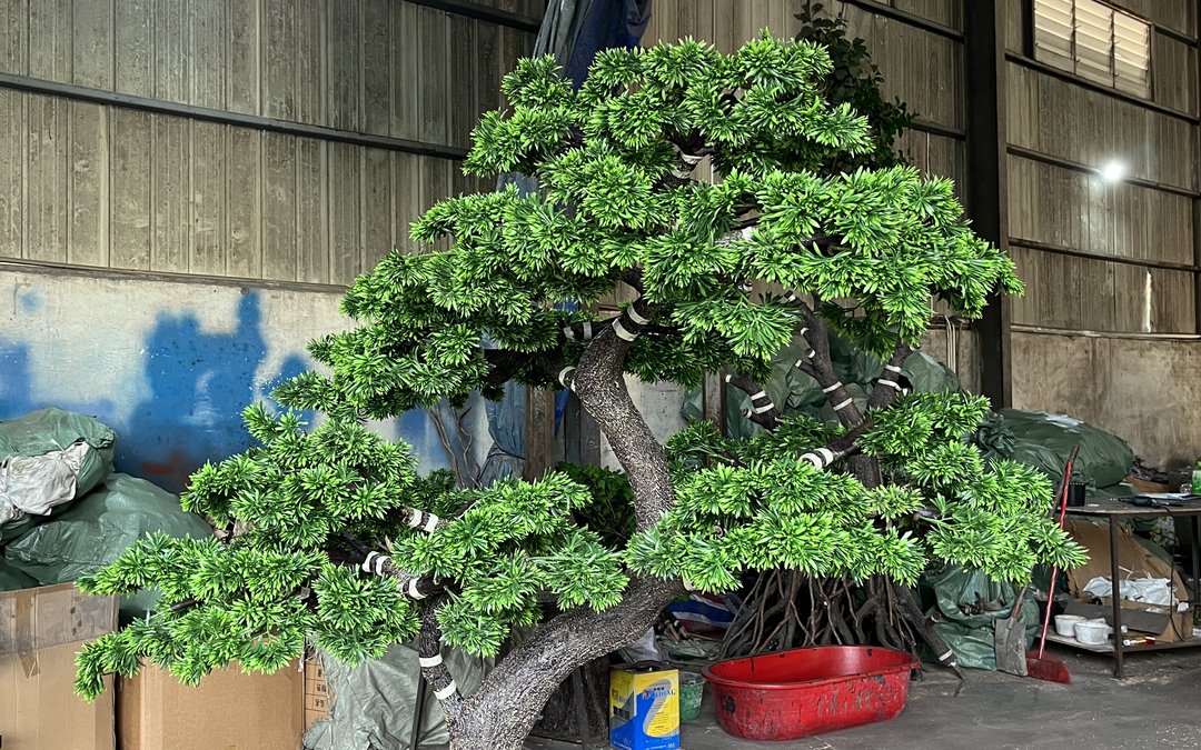 Large artificial tree in the workshop with banded branch collars and a built-out root flare