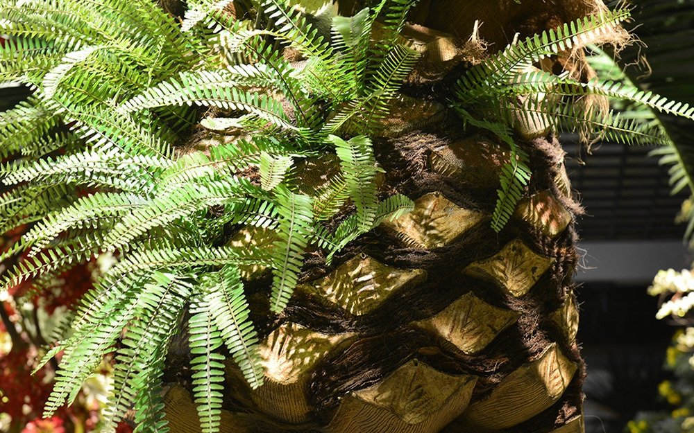 Cast palm trunk shell in detail: moulded bark facets and wrapped fibre banding