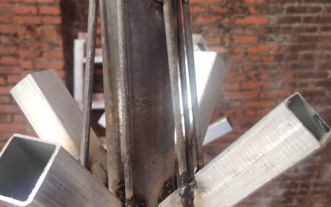 Welded steel armature joint at the base of a large artificial tree frame