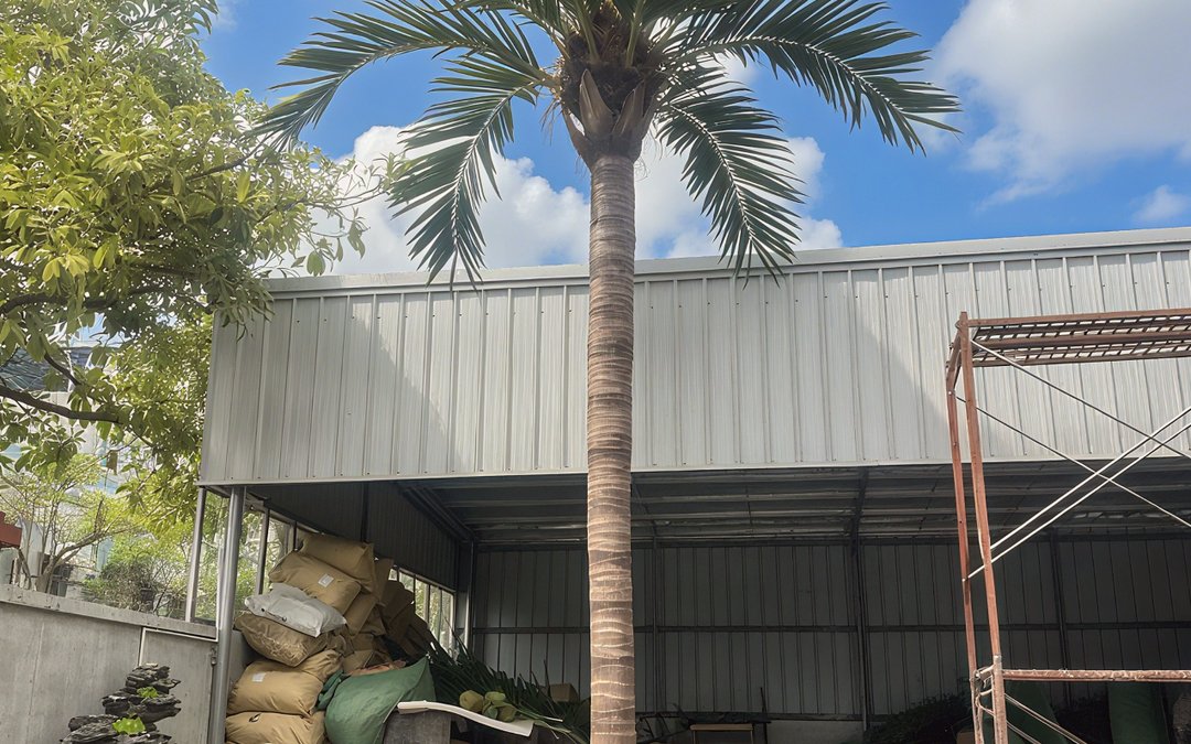 Artificial palm trunk with moulded ring texture standing in the workshop yard