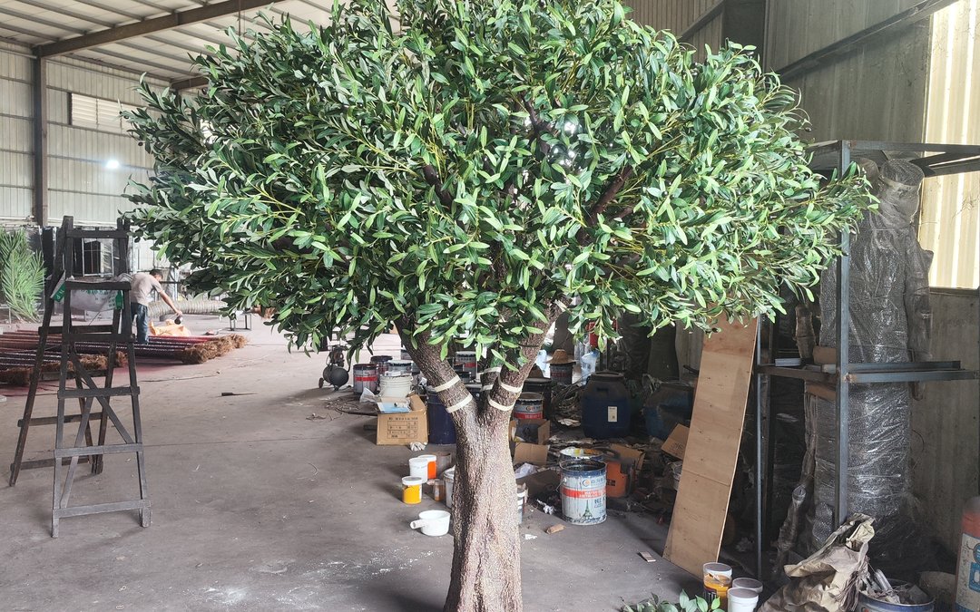 A large specimen in the assembly hall before crating, with trunk joints wrapped and stock staged around it