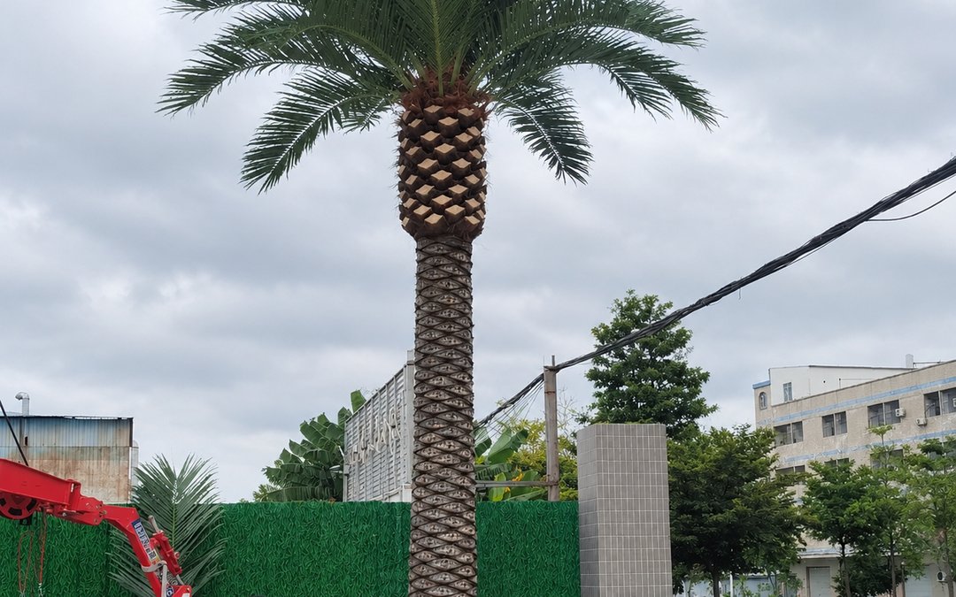 Site installation crew positioning and anchoring a palm trees (site delivery by truck)