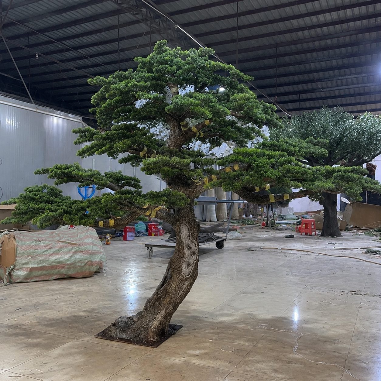 Large artificial cloud topiary pine being finished in our factory workshop