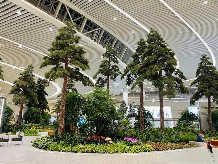Artificial evergreen trees in an airport terminal concourse in Vancouver, Canada