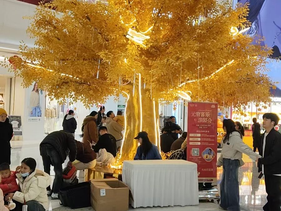 Golden ginkgo tree installed in a shopping mall atrium in Singapore