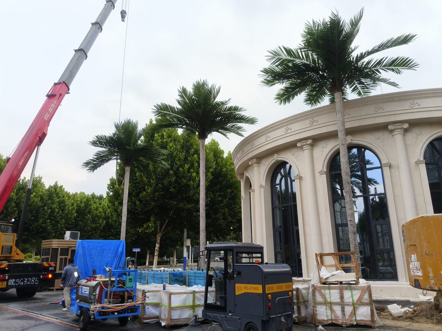 Artificial palm trees installed at a classical-style museum building in Madrid, Spain