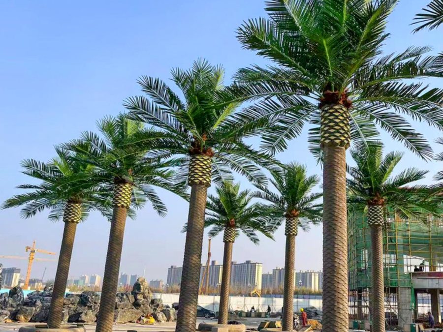 Rows of artificial palm trees along a waterfront promenade in Doha, Qatar