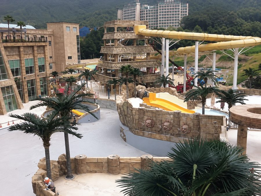 Artificial palm trees around a resort pool deck on the Gold Coast, Australia