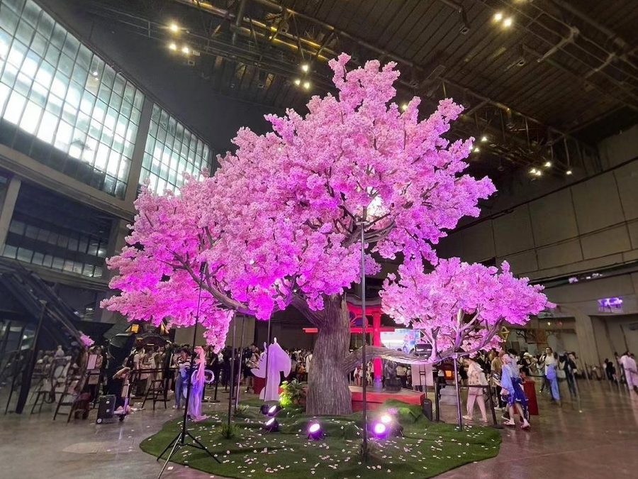 Illuminated artificial cherry blossom trees at an exhibition venue in Paris, France
