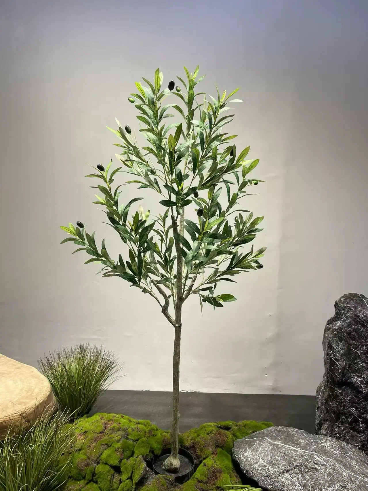 Artificial pine tree in a landscaped showroom setting